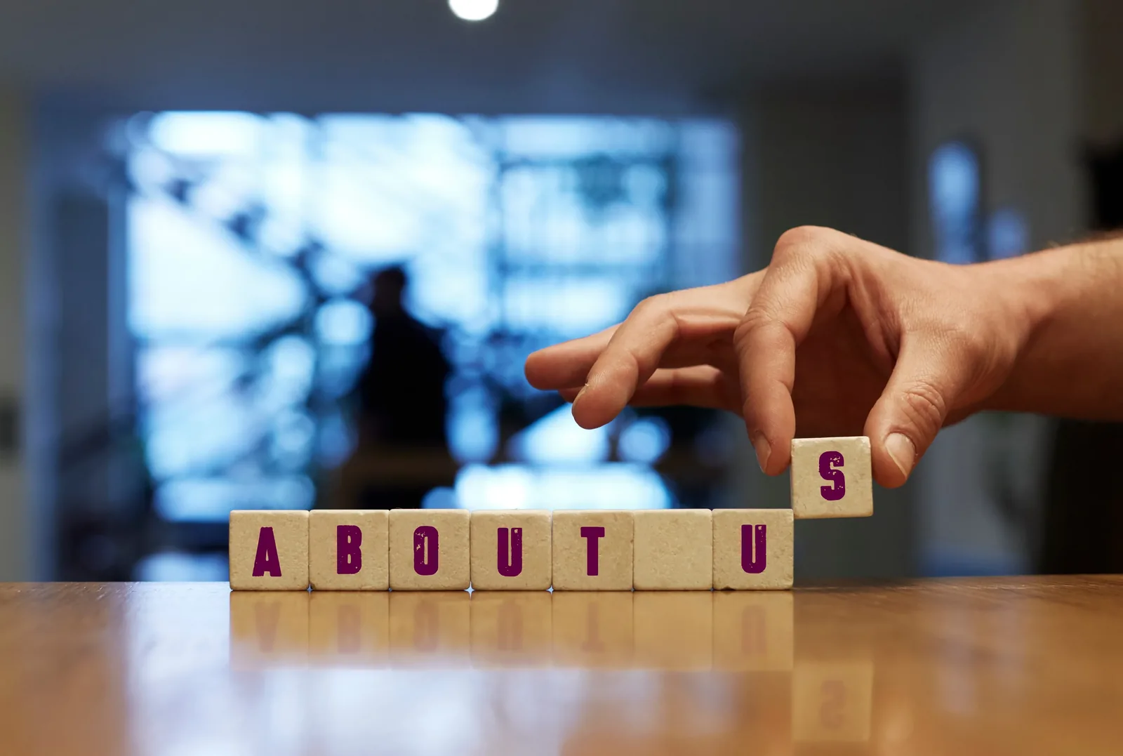 Wooden letter blocks arranged to spell the words about us, introducing Hypnotherapy Pvt Ltd